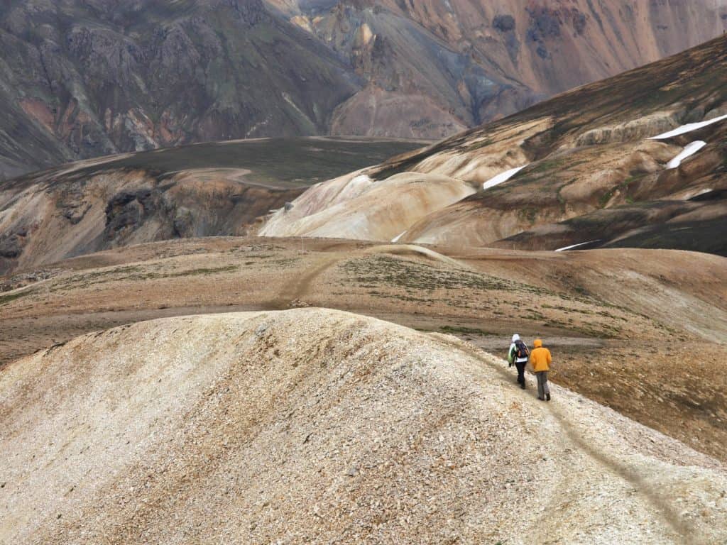 Two hikers in the Rainbow Mountains in Iceland.